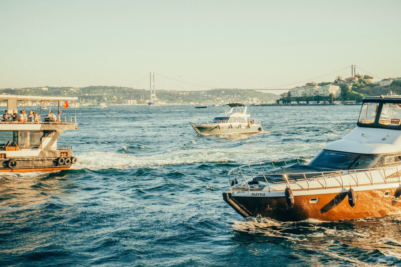 Boats sailing on the Bosphorus with Istanbuls iconic bridge in the background.